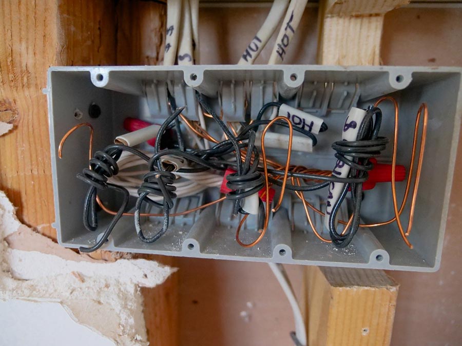 An open grey switchboard with wires